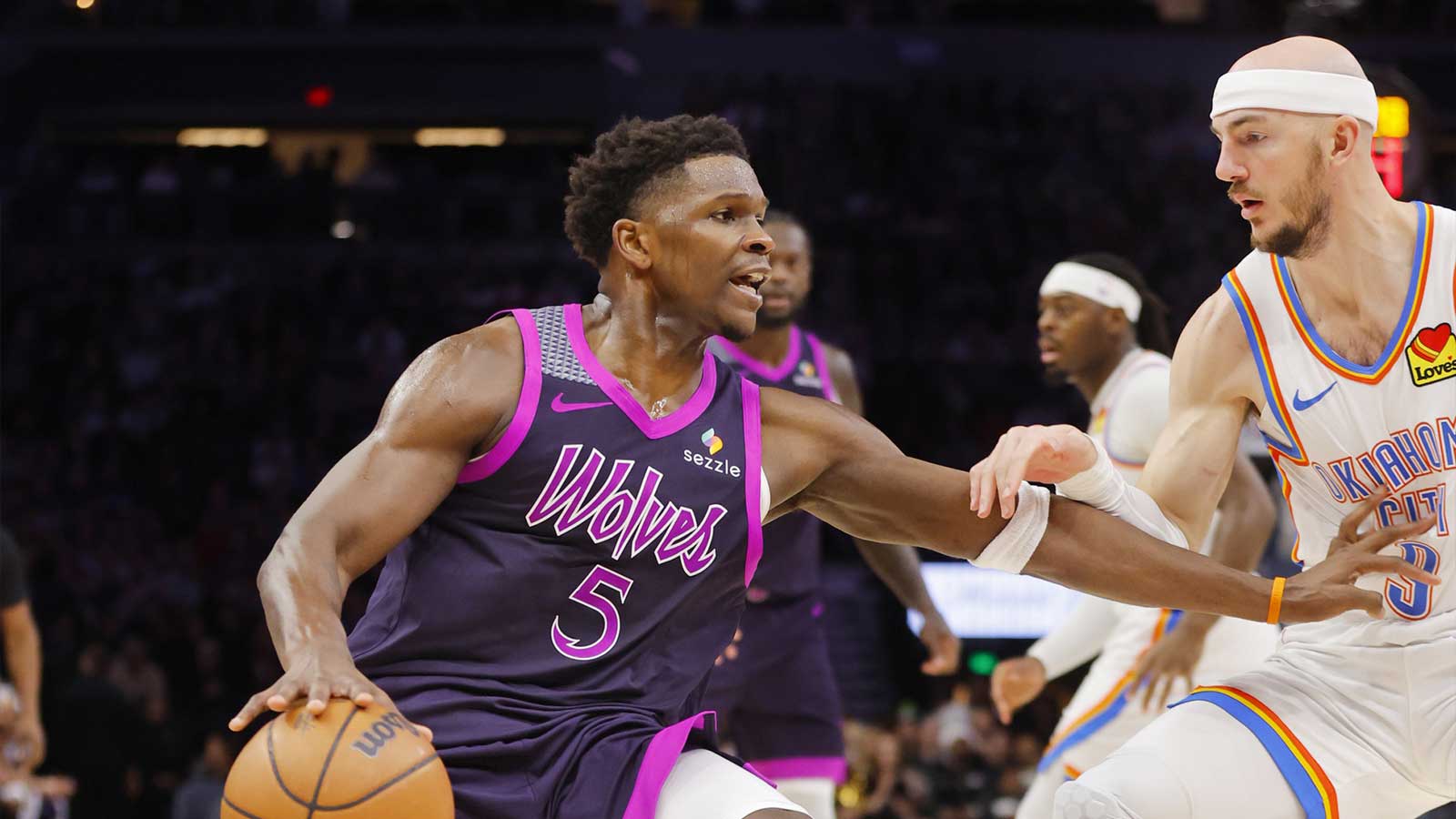 Minnesota Timberwolves guard Anthony Edwards (5) works around Oklahoma City Thunder guard Alex Caruso (9) in the third quarter at Target Center.