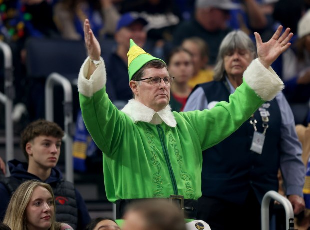 A festive Golden State Warriors fan cheers in the first quarter of their NBA Christmas Day game against the Dallas Mavericks at the Chase Center in San Francisco, Calif., on Thursday, Dec. 25, 2025. (Jane Tyska/Bay Area News Group)