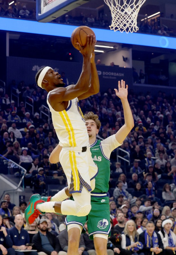 Golden State Warriors' Jimmy Butler III #10 shoots a layup past Dallas Mavericks' Cooper Flagg #32 in the first quarter of their NBA Christmas Day game at the Chase Center in San Francisco, Calif., on Thursday, Dec. 25, 2025. (Jane Tyska/Bay Area News Group)