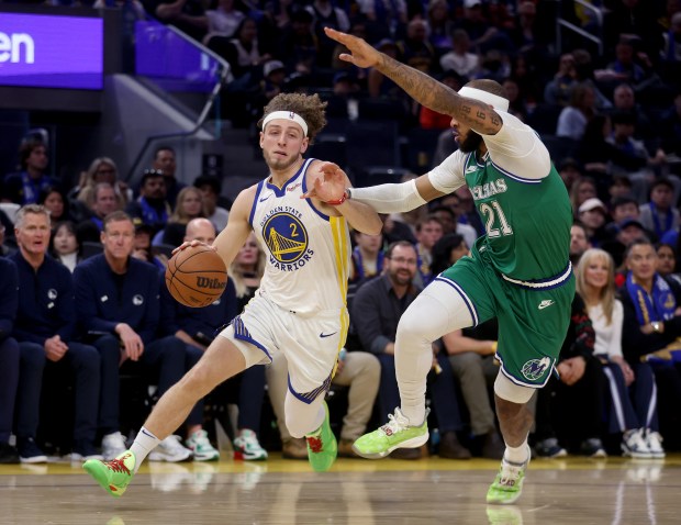 Golden State Warriors' Brandin Podziemski #2 brings the ball down court as he's guarded by Dallas Mavericks' Daniel Gafford #21 in the first quarter of their NBA Christmas Day game at the Chase Center in San Francisco, Calif., on Thursday, Dec. 25, 2025. (Jane Tyska/Bay Area News Group)