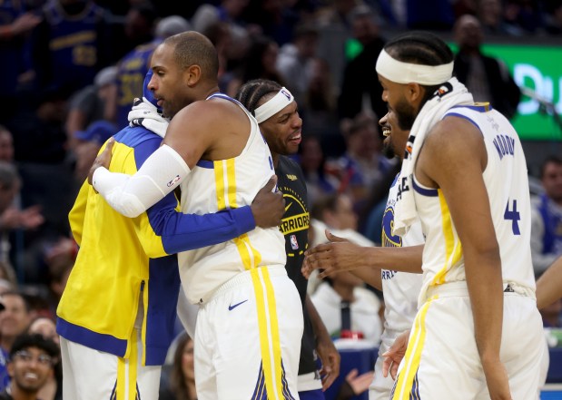 Golden State Warriors' Al Horford #20 is congratulated by Draymond Green #23 during a timeout in the first quarter of their NBA Christmas Day game against the Dallas Mavericks at the Chase Center in San Francisco, Calif., on Thursday, Dec. 25, 2025. (Jane Tyska/Bay Area News Group)