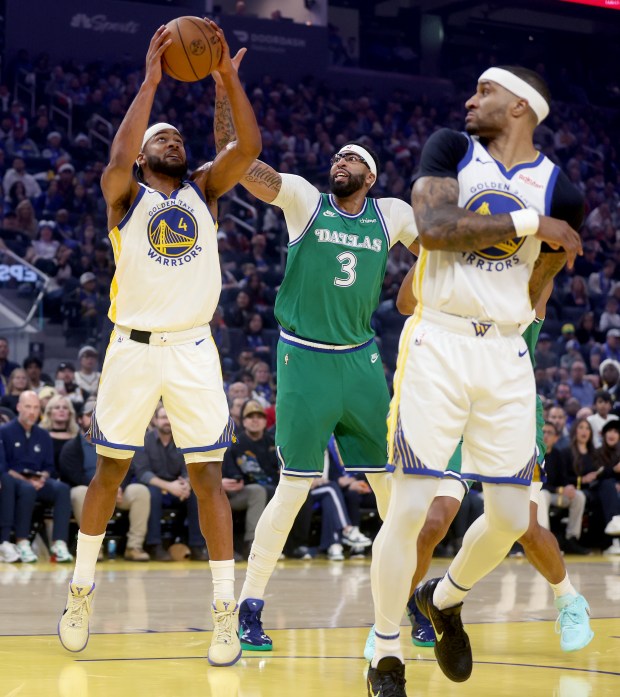 Golden State Warriors' Moses Moody #4 grabs a rebound past Dallas Mavericks' Anthony Davis #3 in the first quarter of their NBA Christmas Day game at the Chase Center in San Francisco, Calif., on Thursday, Dec. 25, 2025. (Jane Tyska/Bay Area News Group)