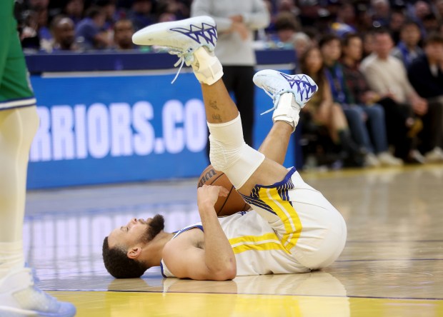 Golden State Warriors' Stephen Curry #30 hits the floor in the second quarter of their Christmas Day NBA game against the Dallas Mavericks at the Chase Center in San Francisco, Calif., on Thursday, Dec. 25, 2025. (Jane Tyska/Bay Area News Group)