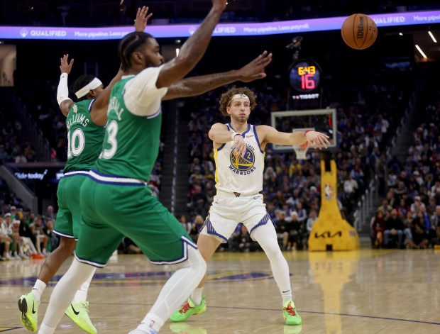 Golden State Warriors' Brandin Podziemski #2 passes as he's double teamed by Dallas Mavericks' Brandon Williams #10 and Naji Marshall #13 in the second quarter of their Christmas Day NBA game at the Chase Center in San Francisco, Calif., on Thursday, Dec. 25, 2025. (Jane Tyska/Bay Area News Group)