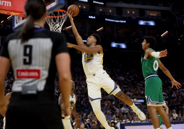 Golden State Warriors' Trayce Jackson-Davis #32 shoots a layup past Dallas Mavericks' Dante Exum #0 in the second quarter of their Christmas Day NBA game at the Chase Center in San Francisco, Calif., on Thursday, Dec. 25, 2025. (Jane Tyska/Bay Area News Group)