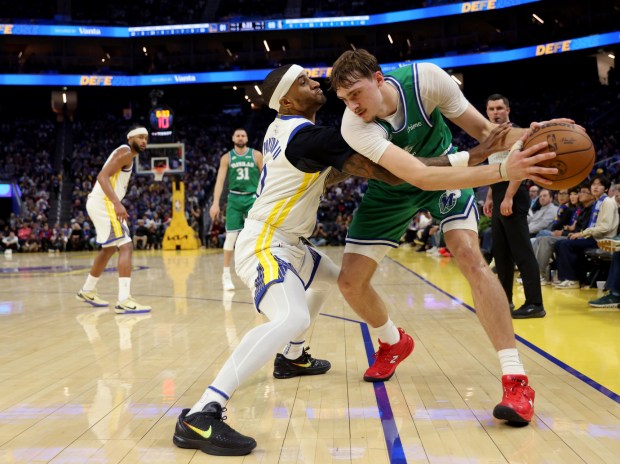 Golden State Warriors' Gary Payton II #0 guards Dallas Mavericks' Cooper Flagg #32 in the third quarter of their Christmas Day NBA game at the Chase Center in San Francisco, Calif., on Thursday, Dec. 25, 2025. (Jane Tyska/Bay Area News Group)