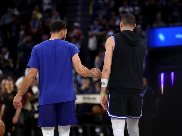 Dallas Mavericks' Klay Thompson #31and former teammate Golden State Warriors' Stephen Curry, #30 left, greet each other before their Christmas Day NBA game at the Chase Center in San Francisco, Calif., on Thursday, Dec. 25, 2025. (Jane Tyska/Bay Area News Group)