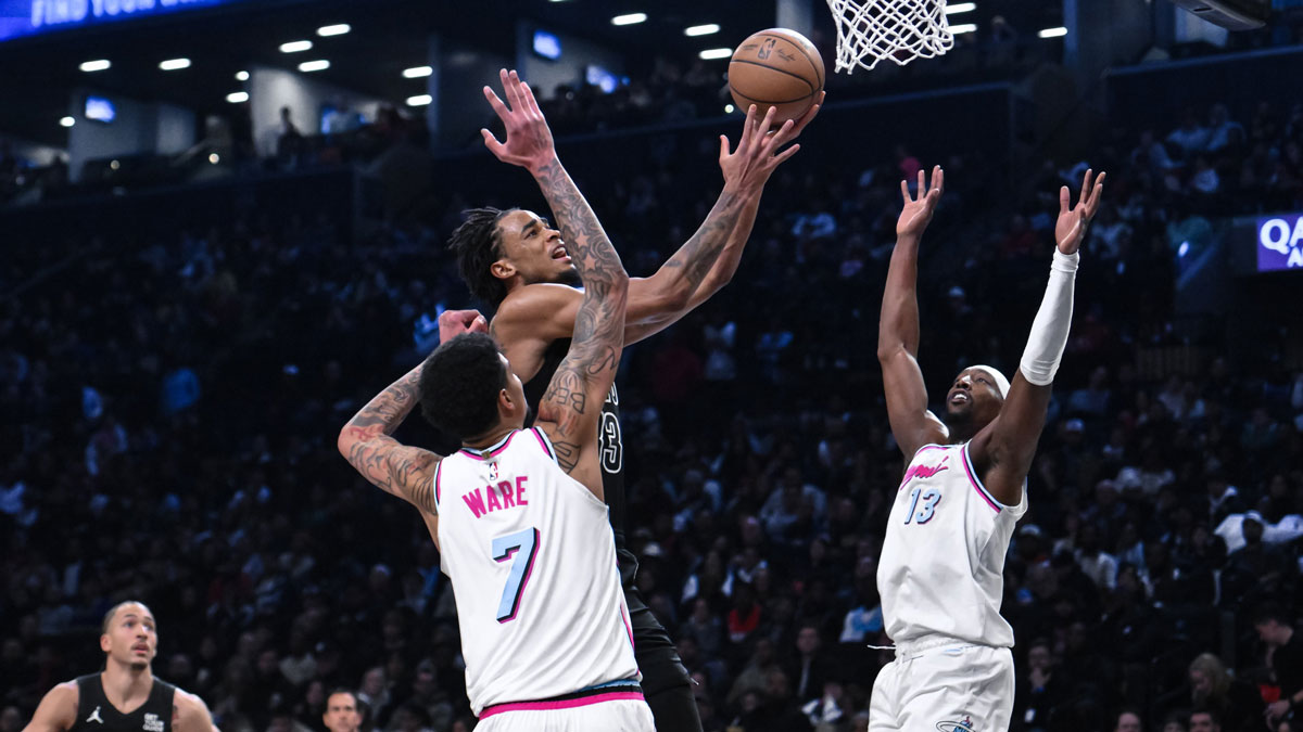 Brooklyn Nets center Nic Claxton (33) drives to the basket against Miami Heat center Kel'el Ware (7) and center Bam Adebayo (13) during the second half at Barclays Center.