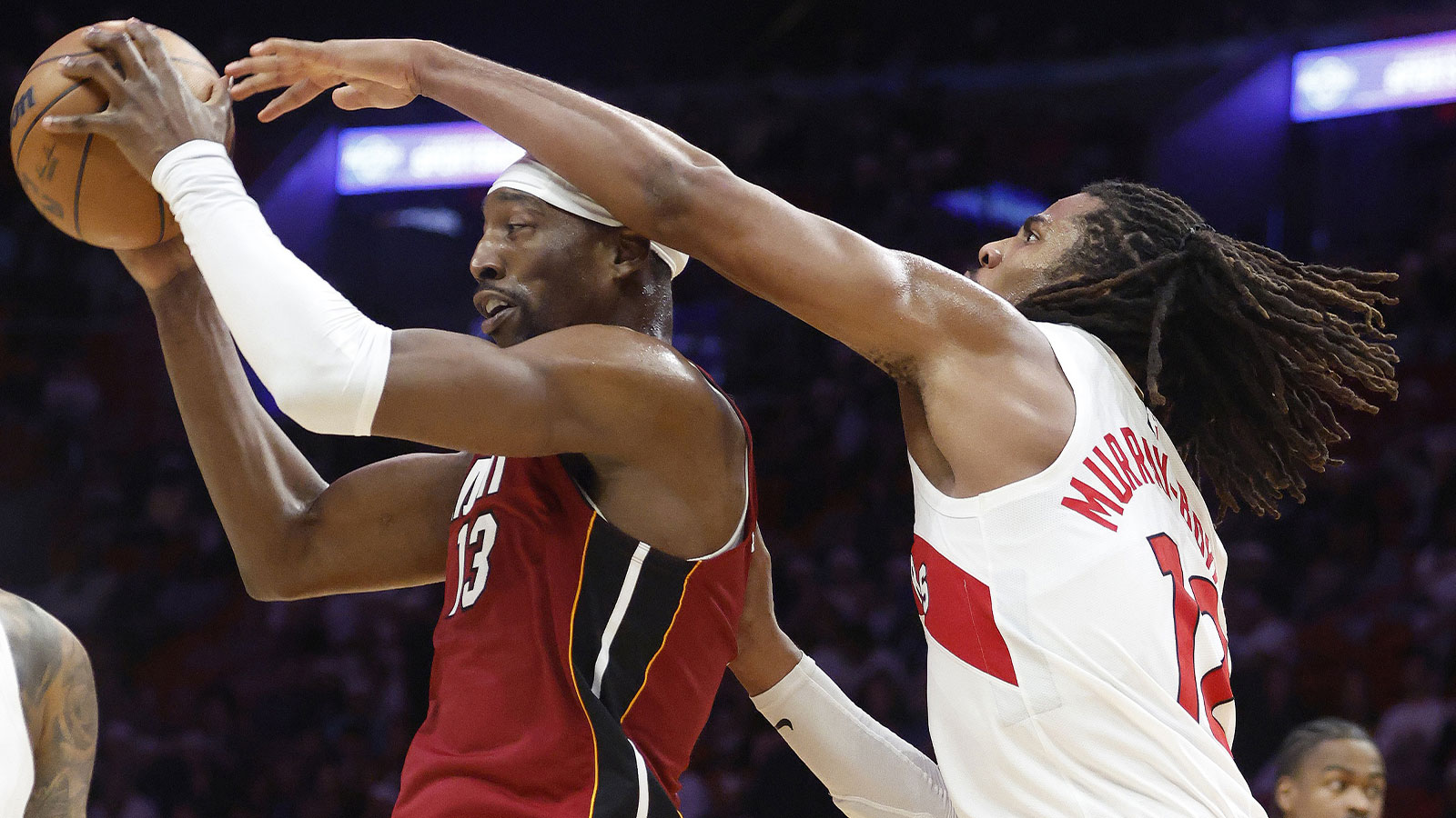 Toronto Raptors forward Collin Murray-Boyles (12) defends Miami Heat center Bam Adebayo (13) during the second half at Kaseya Center.
