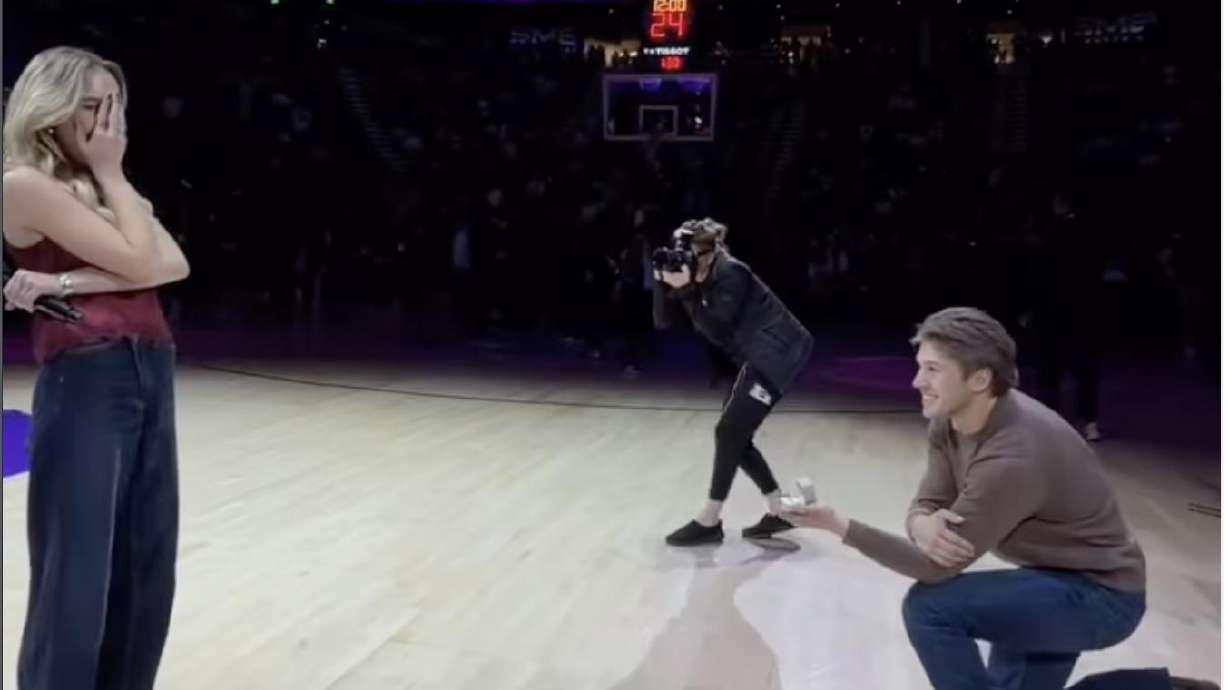 Bridger Gose proposes to his girlfriend Paige Anne after she finishes singing the national anthem a...