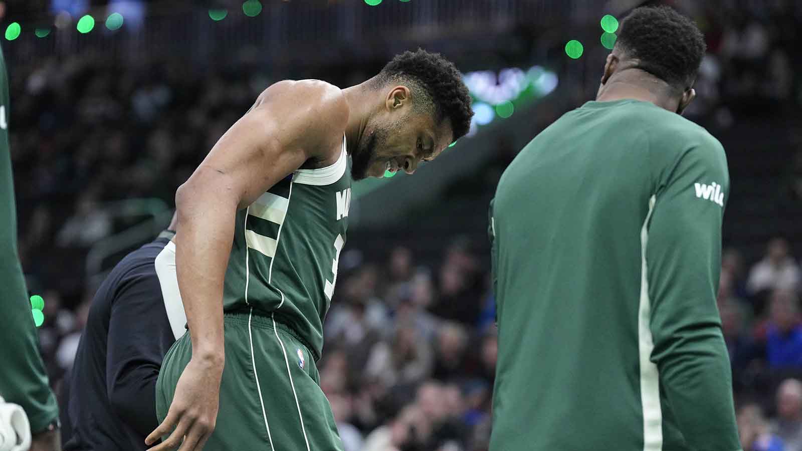 Bucks forward Giannis Antetokounmpo (34) grimaces as he limps off the court after going down with an injury in the first half against the Detroit Pistons at Fiserv Forum