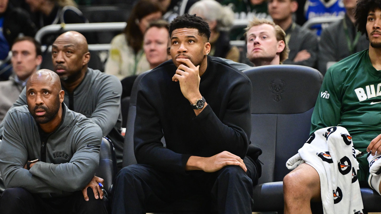 Bucks forward Giannis Antetokounmpo (34) looks on from the bench while recovering from an injury in the second quarter against the Boston Celtics at Fiserv Forum