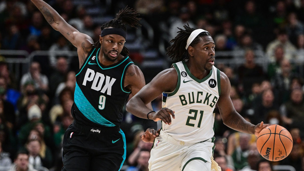 Milwaukee Bucks guard Jrue Holiday (21) drives for the basket against Portland Trail Blazers forward Jerami Grant (9) in the second quarter at Fiserv Forum.