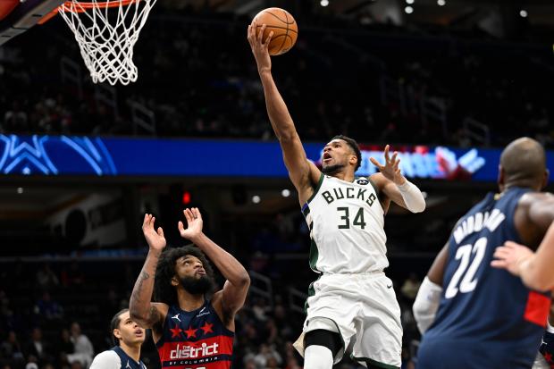Bucks forward Giannis Antetokounmpo goes up to score against the Wizards on Dec. 1, 2025, in Washington. (AP Photo/John McDonnell)