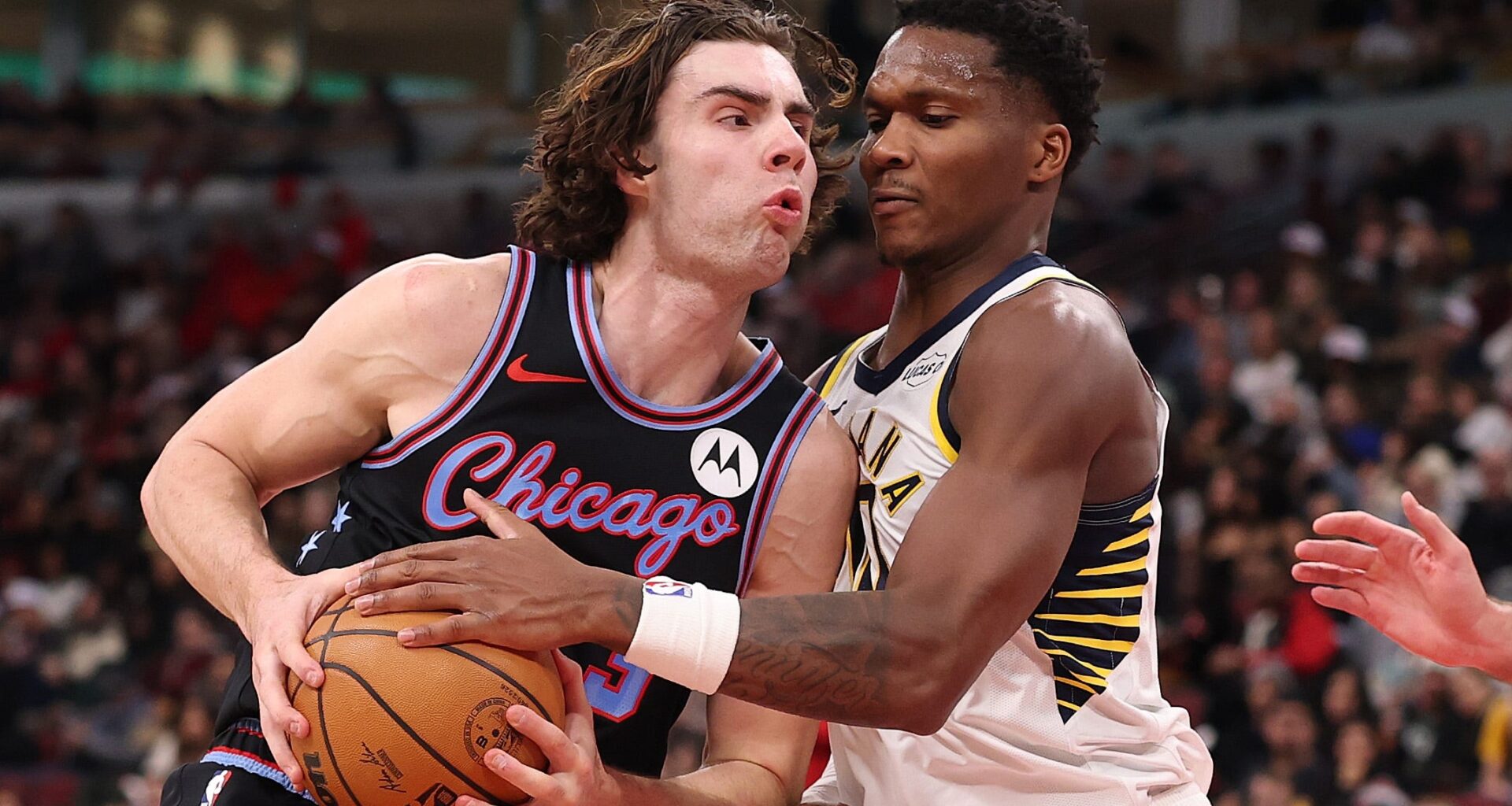 Bulls guard Josh Giddey, left, drives to the hoop against Pacers guard Bennedict Mathurin.