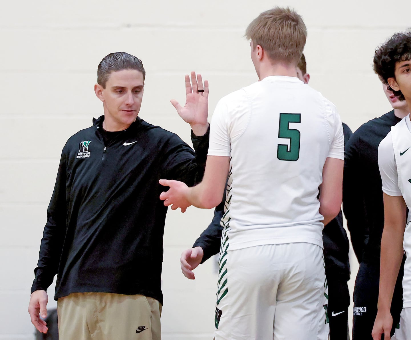 Giving captain Ty Pindel a hand against Westwood, fifth-year coach Ryan Douglass is a proponent of a player-led program. 