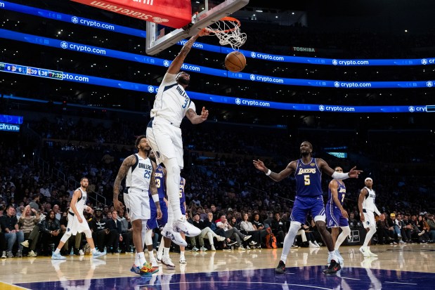 The Mavericks' Anthony Davis dunks during the first half of an NBA Cup game against the Lakers on Nov. 28, 2025, in Los Angeles. (AP Photo/Kyusung Gong)