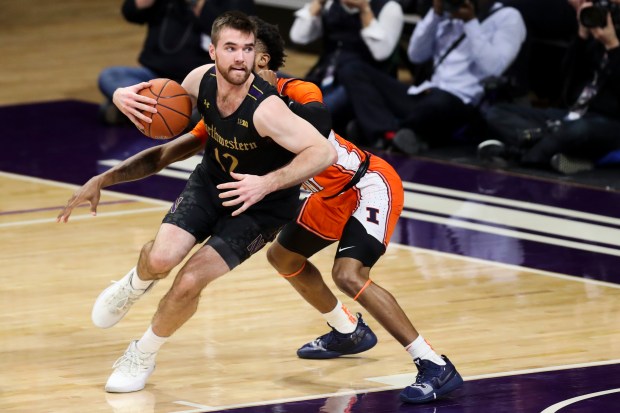 Northwestern Wildcats guard Pat Spencer (12) drives around Illinois Fighting Illini guard Alan Griffin (0) during the second half in Welsh-Ryan Arena at Northwestern University Thursday Feb. 27, 2020 Evanston, Ill. (Armando L. Sanchez/Chicago Tribune)