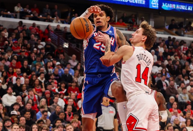 Chicago Bulls forward Matas Buzelis (14) tries to steal the ball from the Philadelphia 76ers forward Dominick Barlow (25) in the fourth quarter, Friday, Dec. 26, 2025, at the United Center in Chicago. (Dominic Di Palermo/Chicago Tribune)