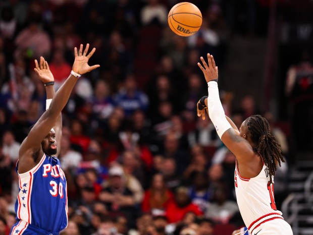 Chicago Bulls guard Ayo Dosunmu (11) makes a three-point field goal in the third quarter during a game against the Philadelphia 76ers, Friday, Dec. 26, 2025, at the United Center in Chicago. (Dominic Di Palermo/Chicago Tribune)