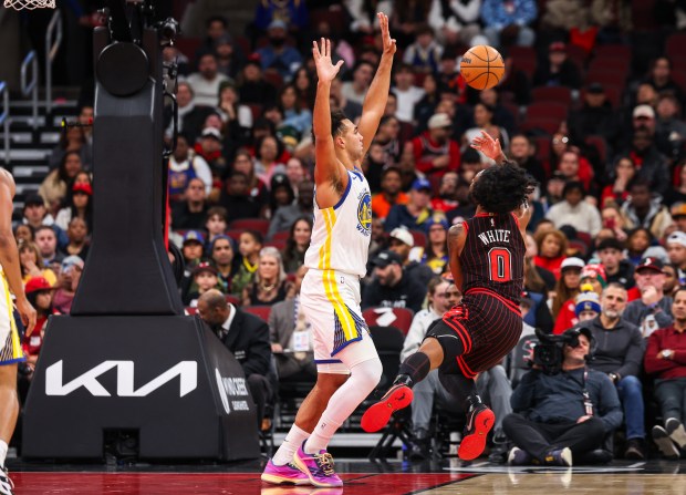Chicago Bulls guard Coby White shoots the ball while falling in the first quarter during a game against the Golden State Warriors, Sunday, Dec. 7, 2025, at the United Center in Chicago. (Dominic Di Palermo/Chicago Tribune)