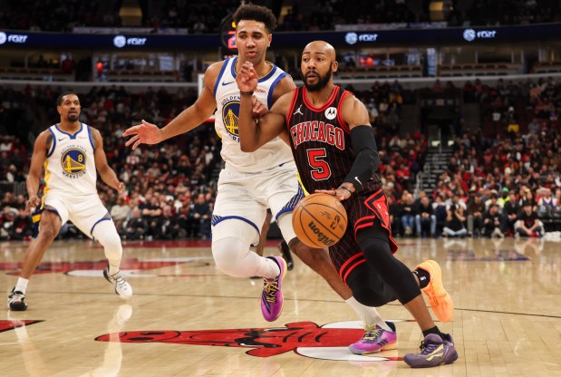 Chicago Bulls guard Jevon Carter (5) drives the lane in the third quarter during a game against the Golden State Warriors, Sunday, Dec. 7, 2025, at the United Center in Chicago. (Dominic Di Palermo/Chicago Tribune)