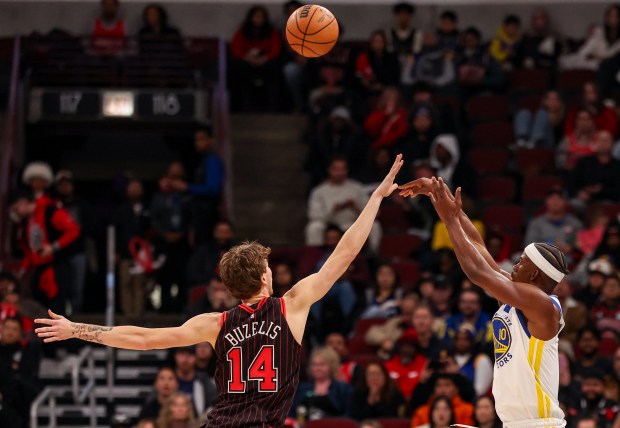Golden State Warriors forward Jimmy Butler makes a 3-point field goal over Chicago Bulls forward Matas Buzelis in the fourth quarter, Sunday, Dec. 7, 2025, at the United Center in Chicago. (Dominic Di Palermo/Chicago Tribune)