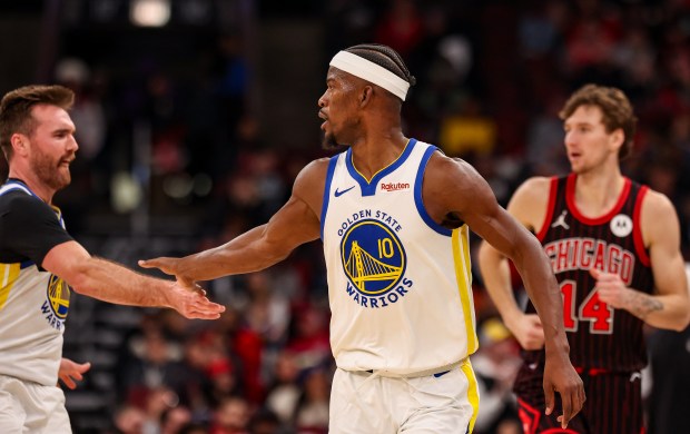 Golden State Warriors forward Jimmy Butler III (10) celebrates his three-point field goal with Golden State Warriors guard Pat Spencer (61) in the fourth quarter during a game against the Chicago Bulls, Sunday, Dec. 7, 2025, at the United Center in Chicago. (Dominic Di Palermo/Chicago Tribune)