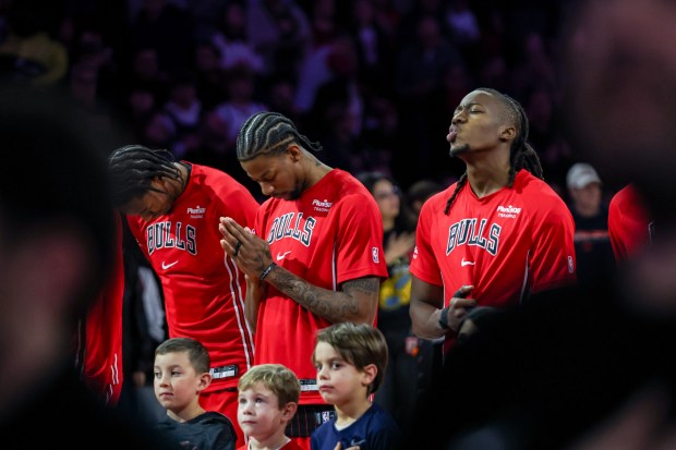 Bulls players stand for the national anthem before a game against the Warriors on Sunday, Dec. 7, 2025, at the United Center. (Dominic Di Palermo/Chicago Tribune)