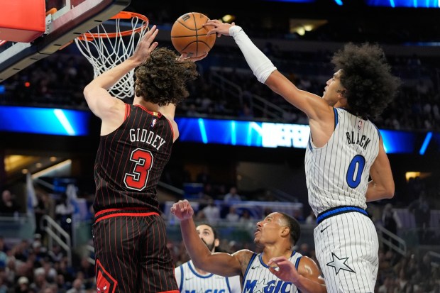 Magic guard Anthony Black blocks a shot by Bulls guard Josh Giddey on Dec. 1, 2025, in Orlando, Fla. (AP Photo/John Raoux)