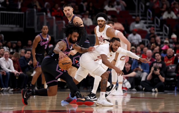 Chicago Bulls guard Coby White (0) pushes off Cleveland Cavaliers guard Darius Garland (10) in the first half of a game at the United Center in Chicago on Dec. 17, 2025. A foul was called on White for the push off. (Chris Sweda/Chicago Tribune)