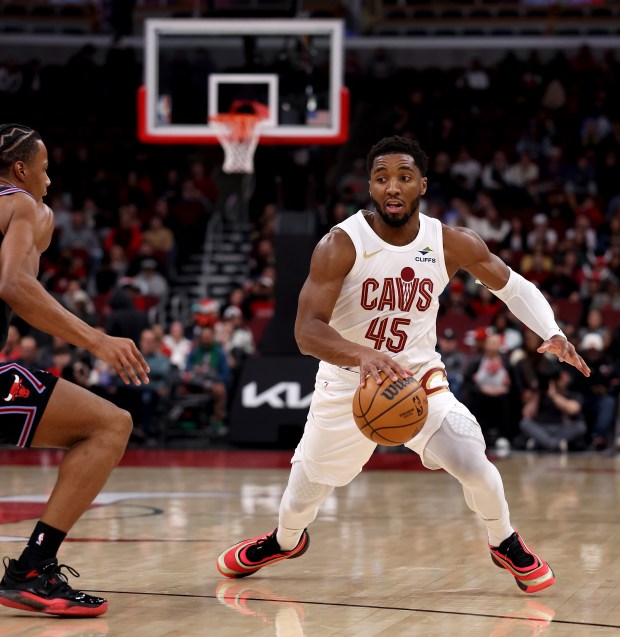 Cleveland Cavaliers guard Donovan Mitchell (45) puts a move on Chicago Bulls forward/guard Isaac Okoro (35) in the first half of a game at the United Center in Chicago on Dec. 17, 2025. (Chris Sweda/Chicago Tribune)