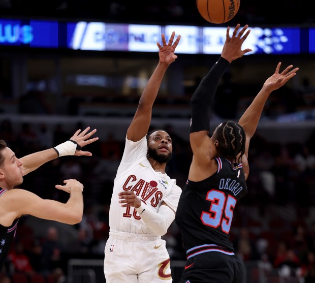 Cleveland Cavaliers guard Darius Garland (10) throws a pass over Chicago Bulls forward/guard Isaac Okoro (35) in the first half of a game at the United Center in Chicago on Dec. 17, 2025. (Chris Sweda/Chicago Tribune)