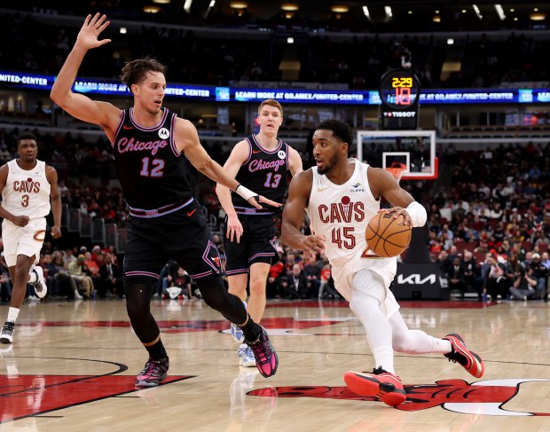 Cleveland Cavaliers guard Donovan Mitchell (45) drives on Chicago Bulls forward/center Zach Collins (12) in the first half of a game at the United Center in Chicago on Dec. 17, 2025. (Chris Sweda/Chicago Tribune)