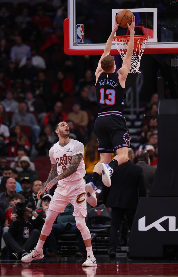 Chicago Bulls guard/forward Kevin Huerter (13) dunks in front of Cleveland Cavaliers guard Lonzo Ball (2) in the first half of a game at the United Center in Chicago on Dec. 17, 2025. (Chris Sweda/Chicago Tribune)