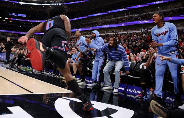 The Chicago Bulls bench cheers after a layup by guard Coby White (0) in the second half of a game against the Cleveland Cavaliers at the United Center in Chicago on Dec. 17, 2025. (Chris Sweda/Chicago Tribune)