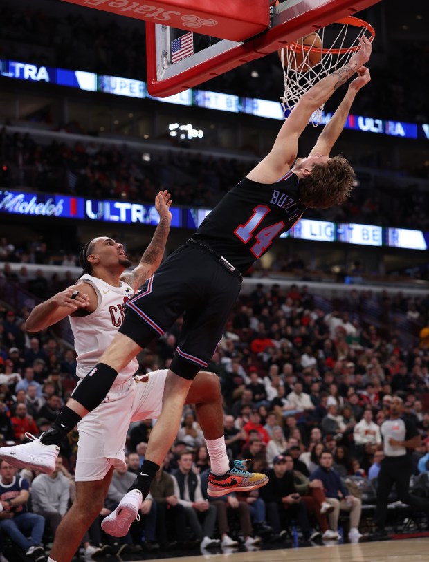 Chicago Bulls forward Matas Buzelis (14) isn't able to complete the dunk as he is fouled by Cleveland Cavaliers guard/forward Jaylon Tyson (20) in the second half of a game at the United Center in Chicago on Dec. 17, 2025. (Chris Sweda/Chicago Tribune)
