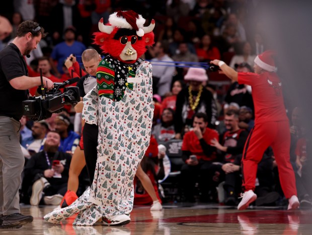 Benny the Bull is seen encased in wrapping paper in the second half of a game between the Chicago Bulls and the Cleveland Cavaliers at the United Center in Chicago on Dec. 17, 2025. (Chris Sweda/Chicago Tribune)