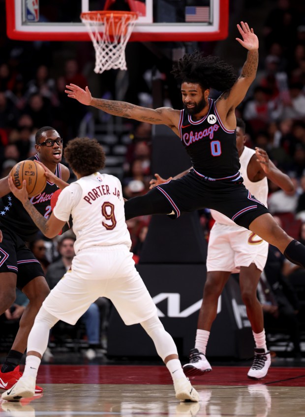 Chicago Bulls guard Coby White (0) tries to block a pass attempt by Cleveland Cavaliers guard Craig Porter Jr. (9) in the second half of a game at the United Center in Chicago on Dec. 17, 2025. (Chris Sweda/Chicago Tribune)