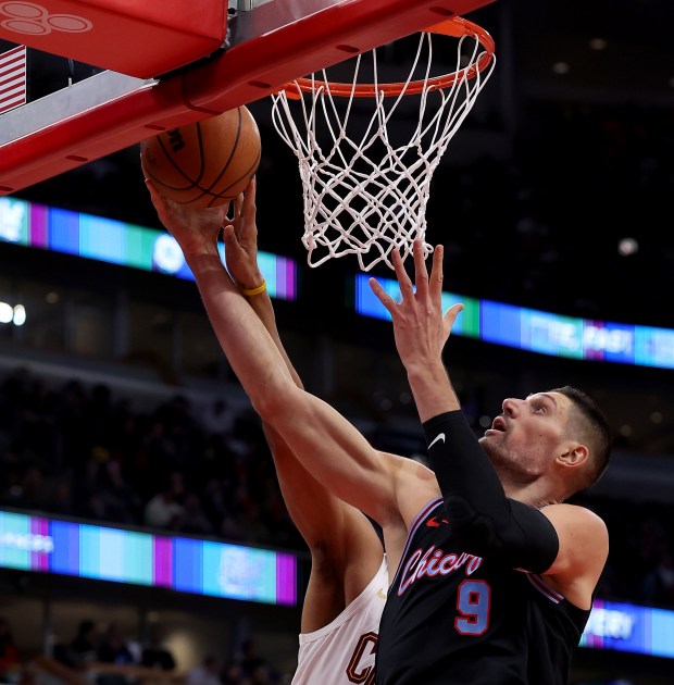 Chicago Bulls center Nikola Vučević (9) pulls down a rebound in the first half of a game against the Cleveland Cavaliers at the United Center in Chicago on Dec. 17, 2025. (Chris Sweda/Chicago Tribune)