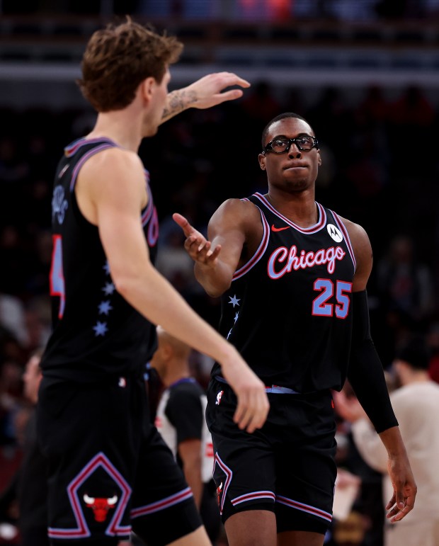 Chicago Bulls forward Matas Buzelis (14) and forward/center Jalen Smith (25) congratulate one another going into a timeout in the first half of a game against the Cleveland Cavaliers at the United Center in Chicago on Dec. 17, 2025. (Chris Sweda/Chicago Tribune)