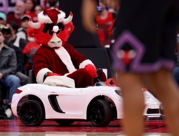 Benny the Bull, dressed as Santa Claus, drives a small car around the court during a timeout in the second half of a game between the Chicago Bulls and the Cleveland Cavaliers at the United Center in Chicago on Dec. 17, 2025. (Chris Sweda/Chicago Tribune)