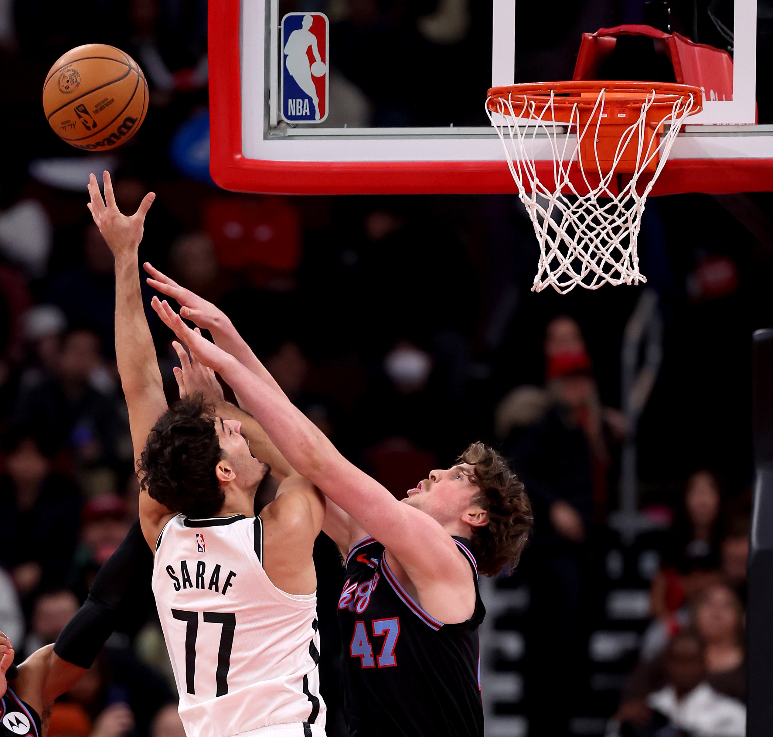 Chicago Bulls center Lachlan Olbrich (47) tries to block the shot of Brooklyn Nets guard Ben Saraf (77) in the first half of a game at the United Center in Chicago on Dec. 3, 2025. (Chris Sweda/Chicago Tribune)