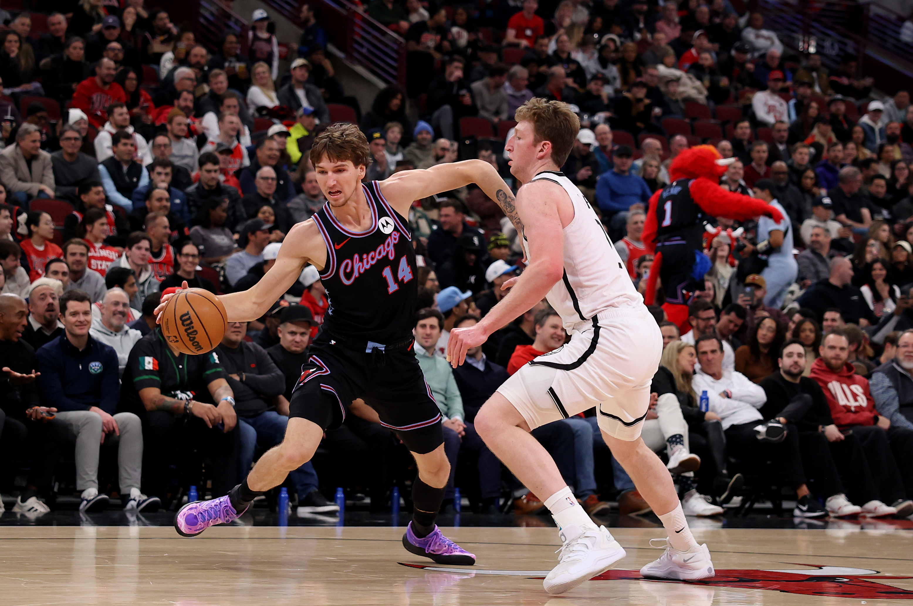 Chicago Bulls forward Matas Buzelis (14) puts a move on Brooklyn Nets forward Danny Wolf (2) in the first half of a game at the United Center in Chicago on Dec. 3, 2025. (Chris Sweda/Chicago Tribune)