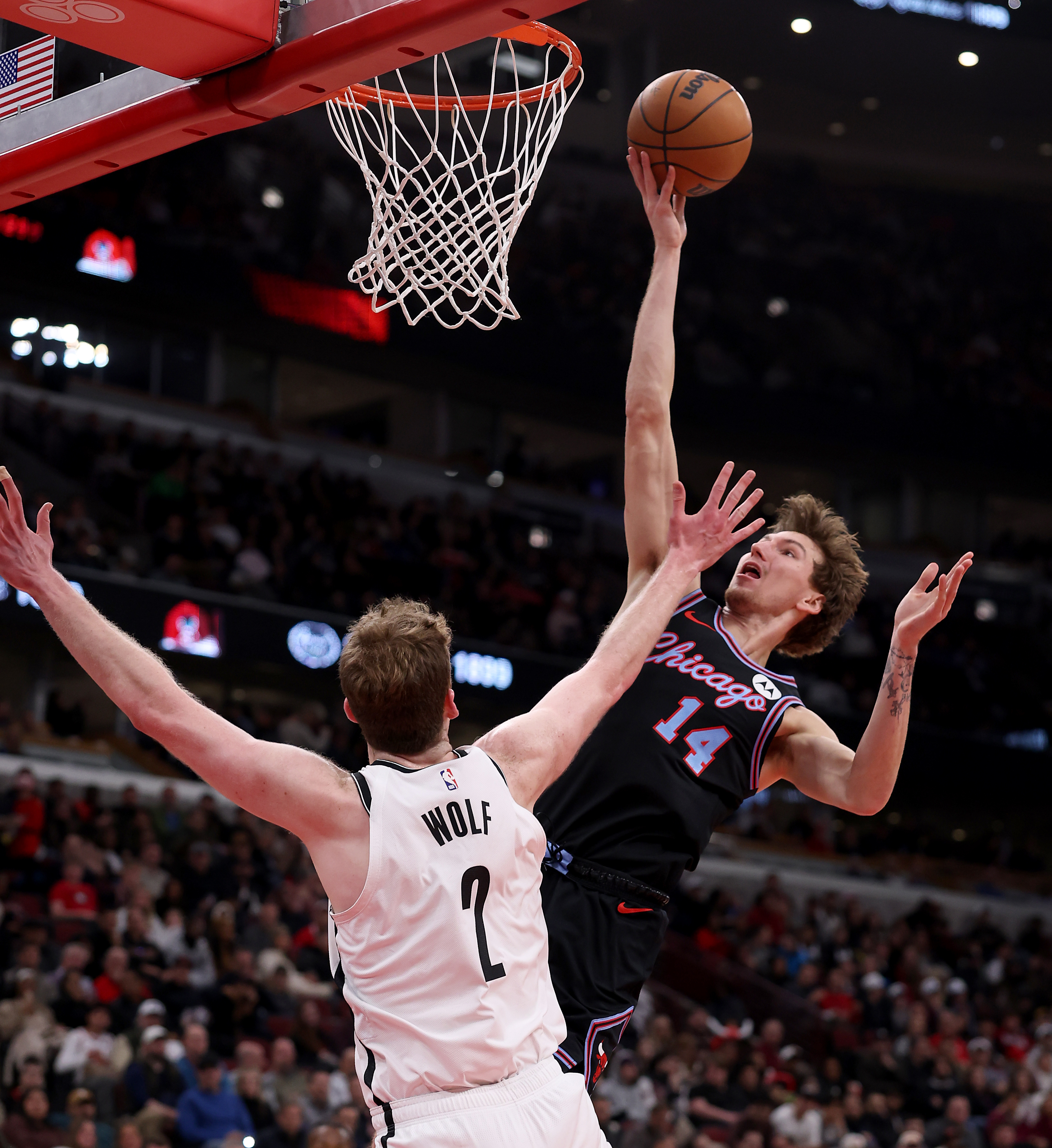 Chicago Bulls forward Matas Buzelis (14) drives in for a layup on Brooklyn Nets forward Danny Wolf (2) in the first half of a game at the United Center in Chicago on Dec. 3, 2025. (Chris Sweda/Chicago Tribune)