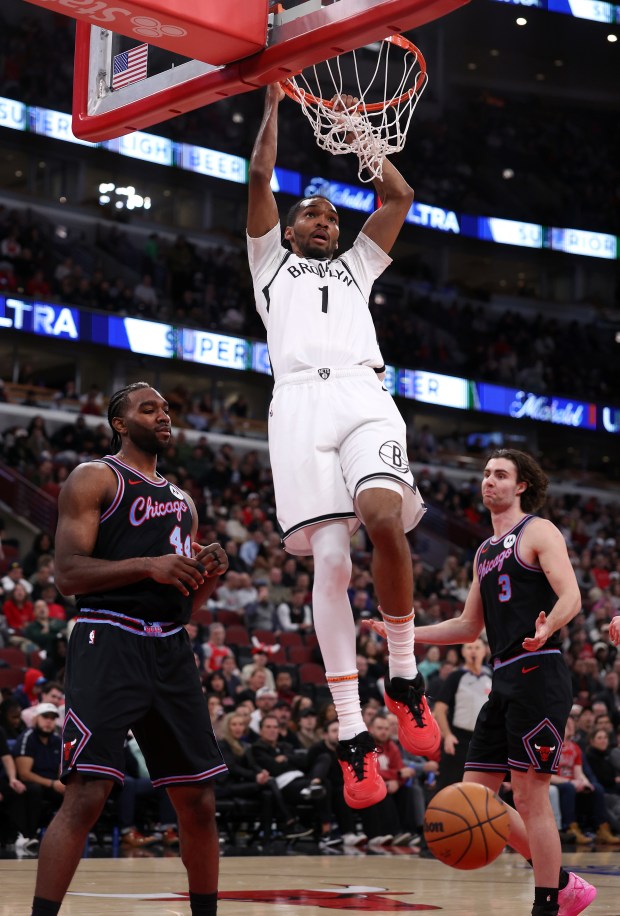 Brooklyn Nets forward Ziaire Williams (1) dunks the ball beside Chicago Bulls forward Patrick Williams (44) and guard Josh Giddey (3) in the second half of a game at the United Center in Chicago on Dec. 3, 2025. (Chris Sweda/Chicago Tribune)