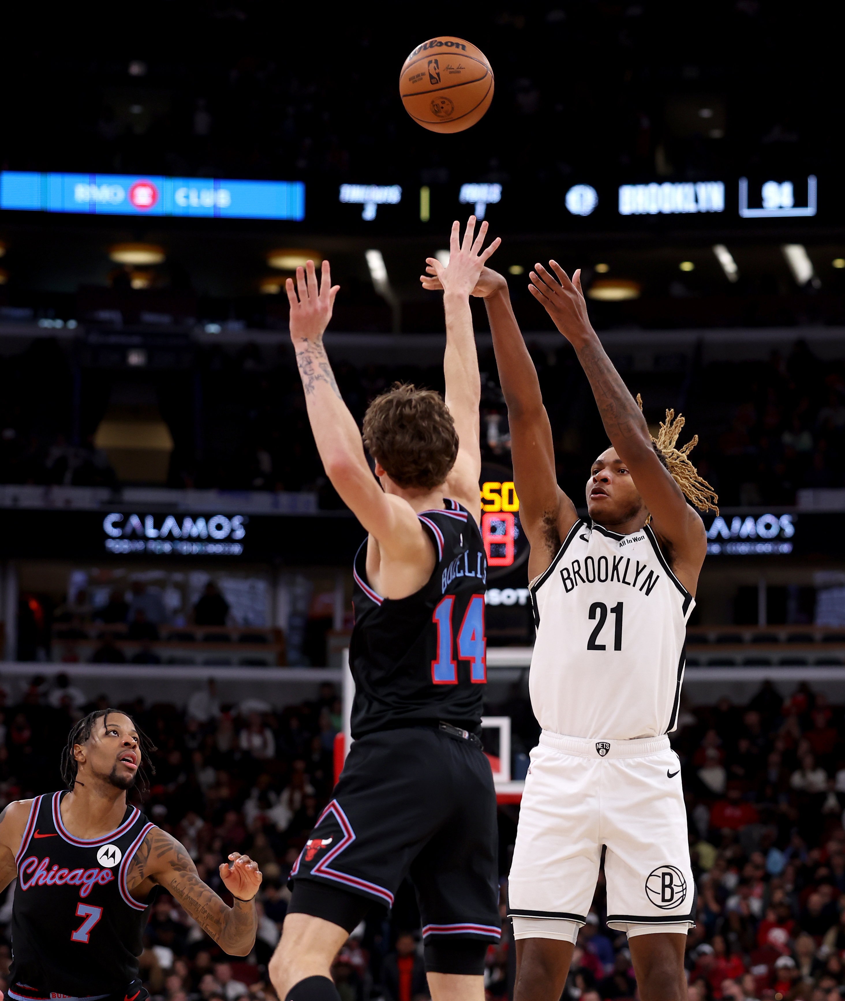 Brooklyn Nets forward/center Noah Clowney (21) shoots a 3-pointer over Chicago Bulls forward Matas Buzelis (14) in the second half of a game at the United Center in Chicago on Dec. 3, 2025. (Chris Sweda/Chicago Tribune)