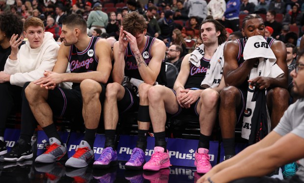 Chicago Bulls players, including Nikola Vučević, Matas Buzelis, Josh Giddey, and Patrick Williams, sit on the bench late in the second half of a game against the Brooklyn Nets at the United Center in Chicago on Dec. 3, 2025. (Chris Sweda/Chicago Tribune)