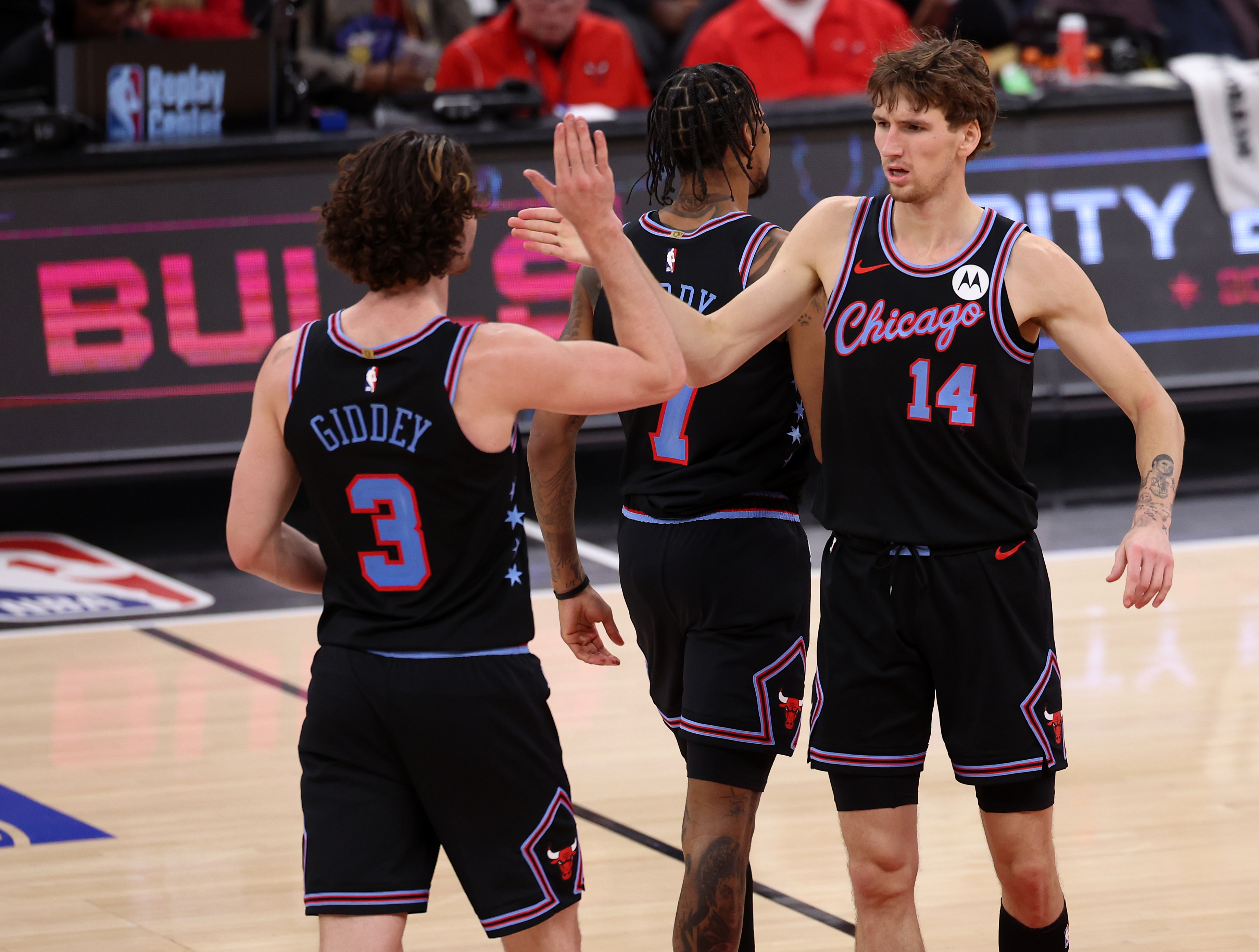 Chicago Bulls guard Josh Giddey (3) and forward Matas Buzelis (14) celebrate after Buzelis scored in the second half of a game against the Brooklyn Nets at the United Center in Chicago on Dec. 3, 2025. (Chris Sweda/Chicago Tribune)