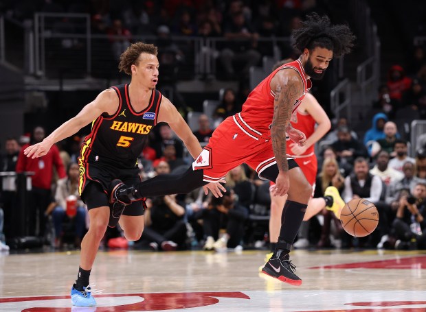 Coby White of the Chicago Bulls draws a foul from Dyson Daniels of the Atlanta Hawks during the fourth quarter at State Farm Arena on Dec. 21, 2025, in Atlanta. (Kevin C. Cox/Getty Images)